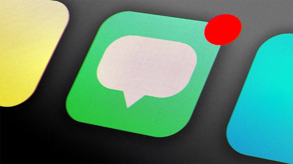 A messaging app’s speech-bubble icon with a red notification dot